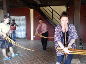 Guests having fun learning a Hmong traditional music instrument in Laos, Luang Prabang