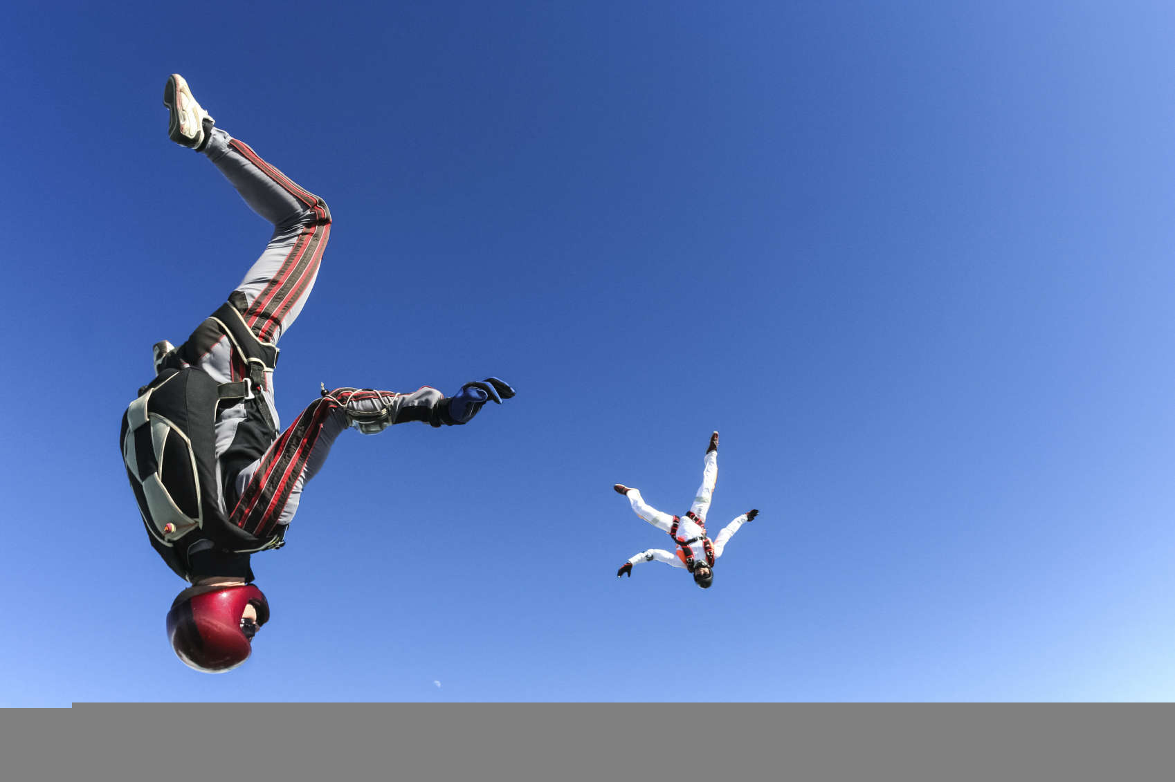 A group of paratroopers in a free style free fall. Photo credit: istock