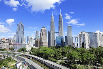 Book early to get good rates when visiting Asia. (Image credit of Kuala Lumpur skyline: leungchopan/iStock)